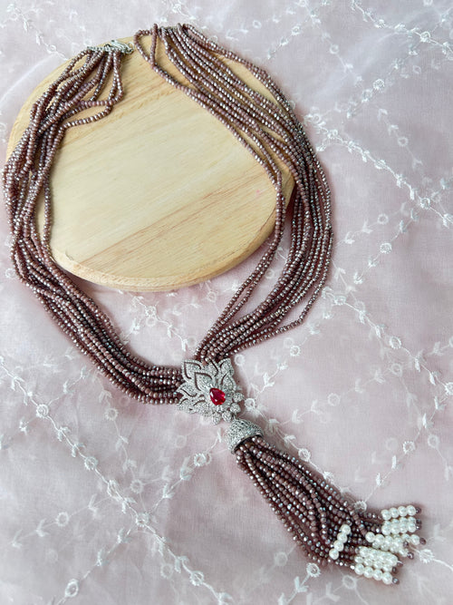 Adaa Necklace detail view showing hydro stones, a white metal pendant and red stone.