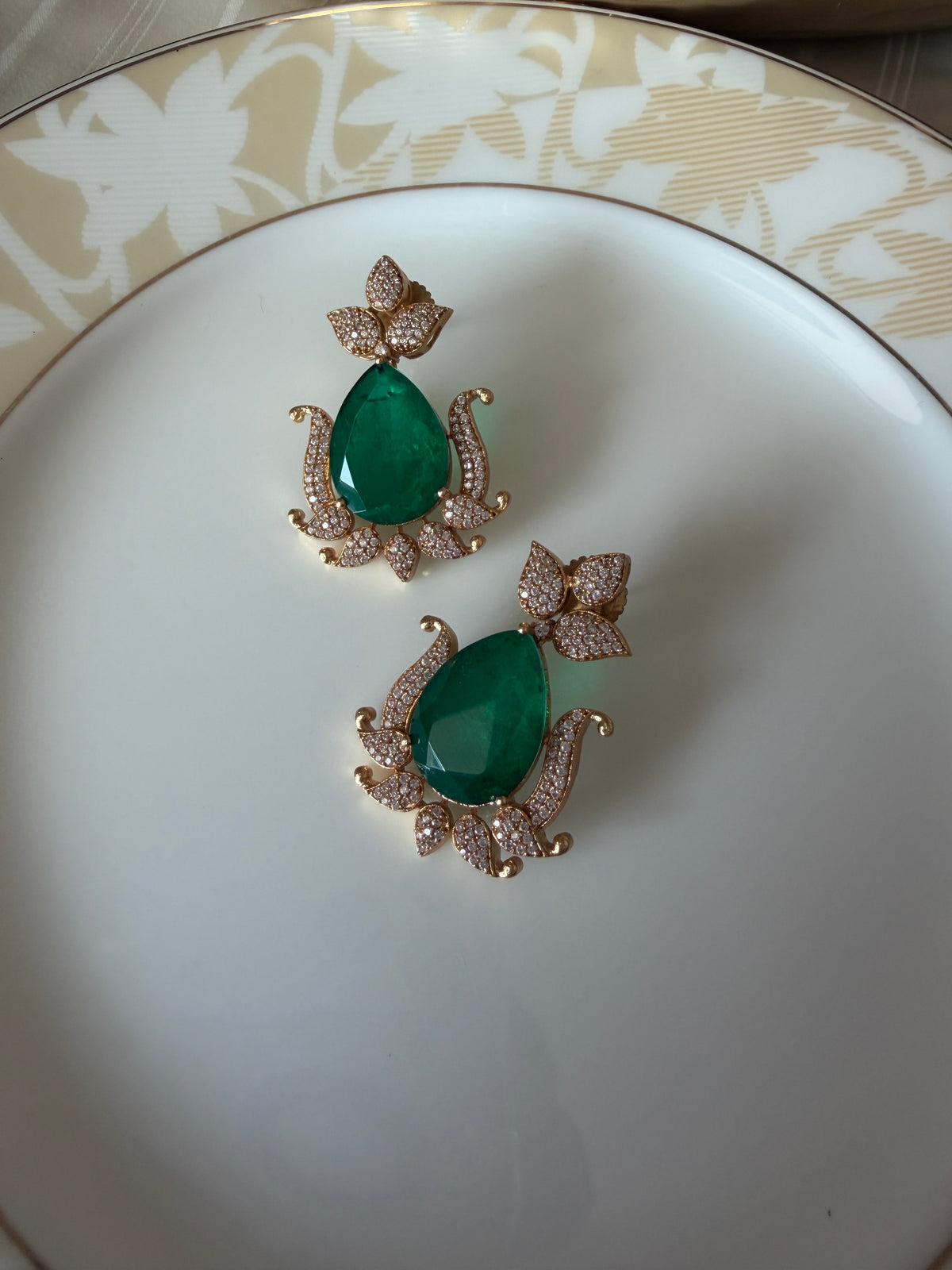 Gul Earrings side view showing double green stones and American diamond detailing.