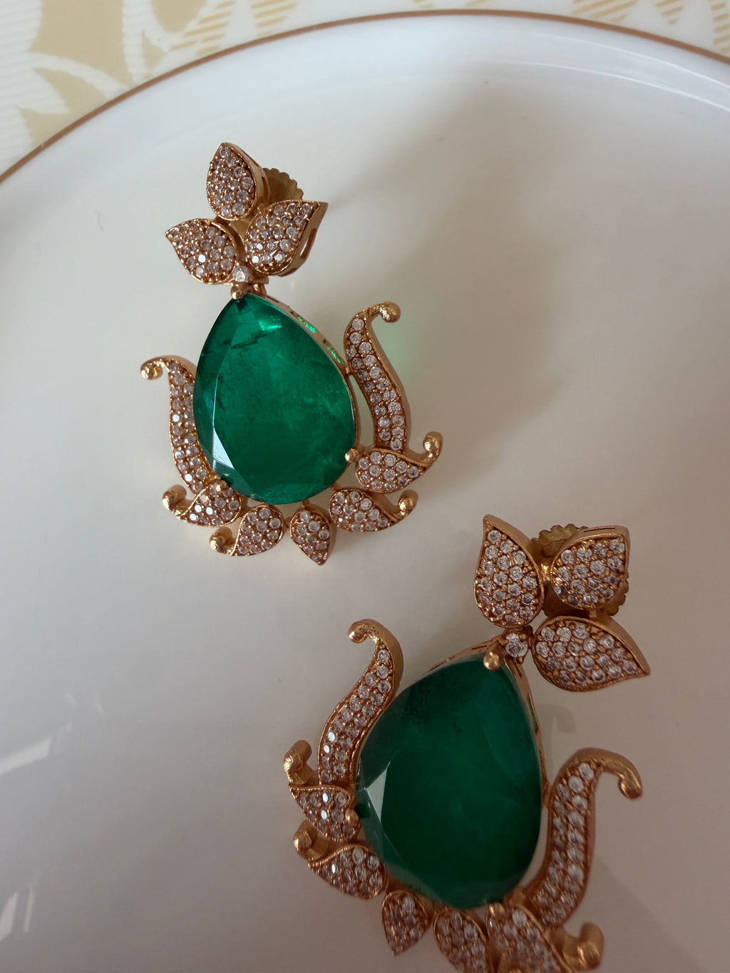 Gul Earrings detail view highlighting green stone color and American diamond shine.