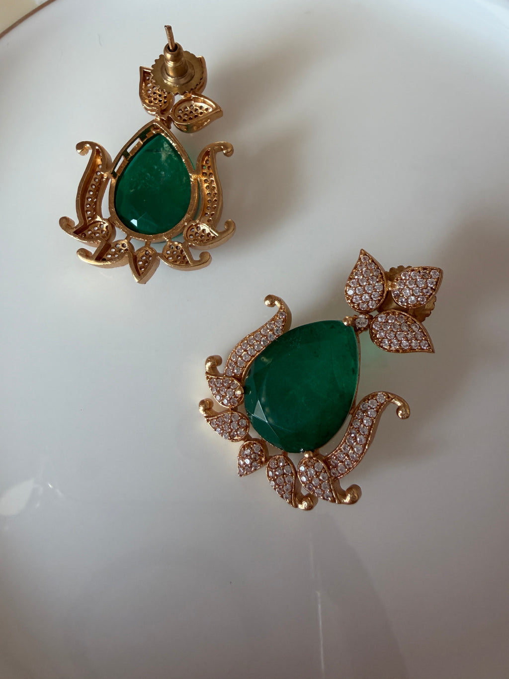Gul Earrings styled product view with green stones and American diamond accents.