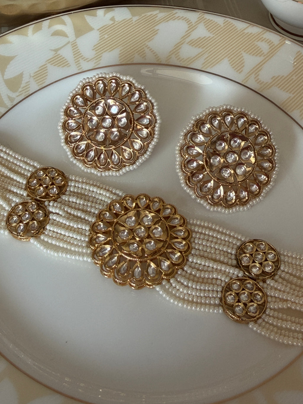 Detailed front view of Renuka pearl necklace motifs and matching oversized stud earrings