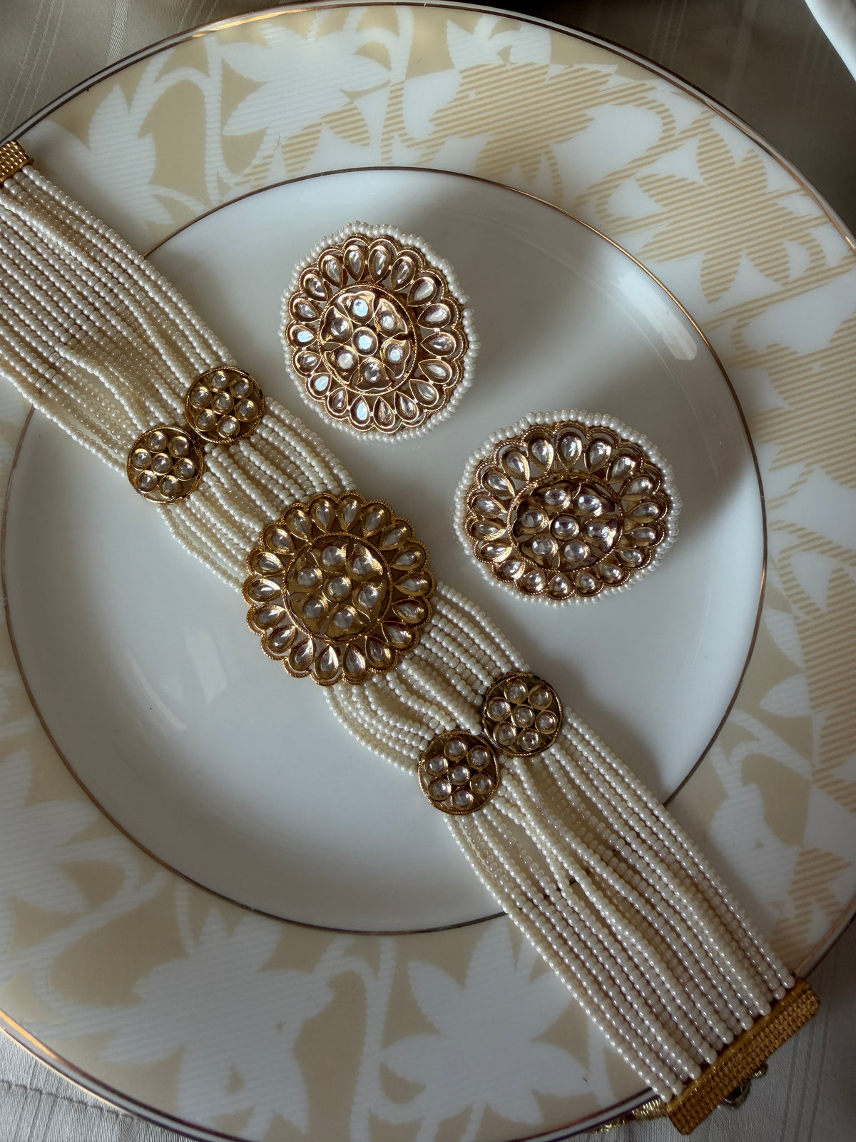 Renuka multi-strand ivory pearl choker and matching round stud earrings in a full-set view