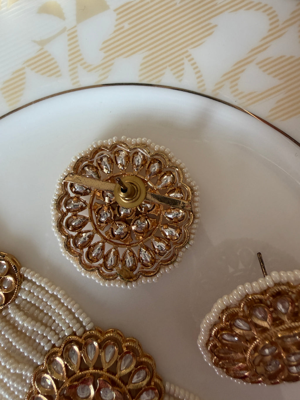 Rear close-up of the Renuka statement stud earring clasp and gold-tone setting