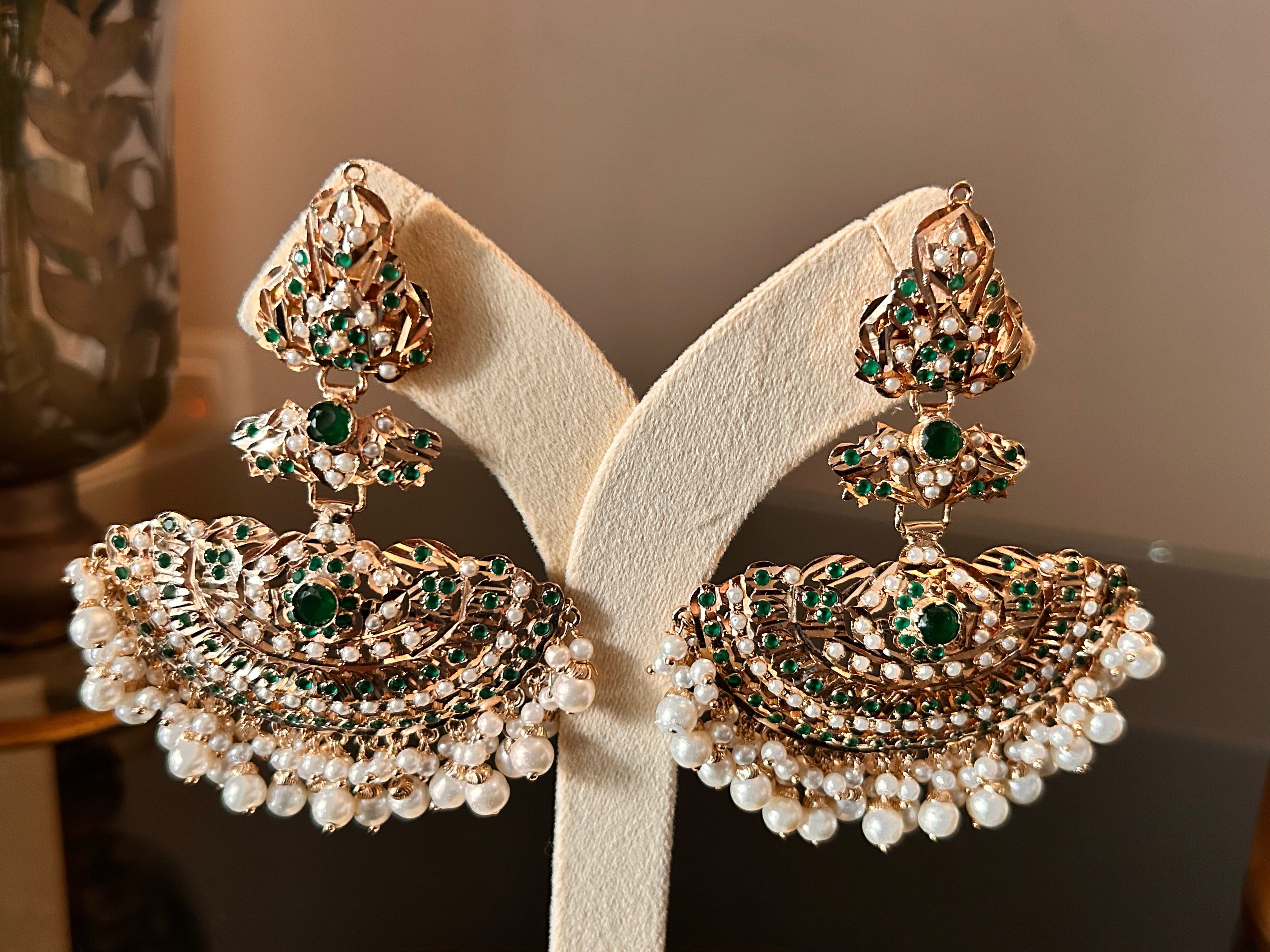 Close-up of the Khwahish earring pair, highlighting green and pink stonework, gold-tone detailing and rows of pearl-like drops.