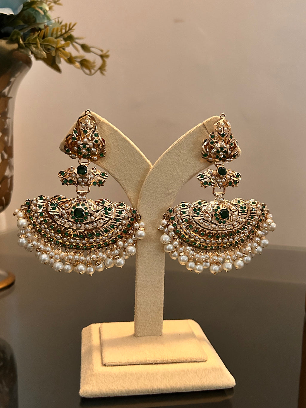 Alternate full-stand view of Khwahish green and pink stone earrings with gold-tone details and pearl-like drops.