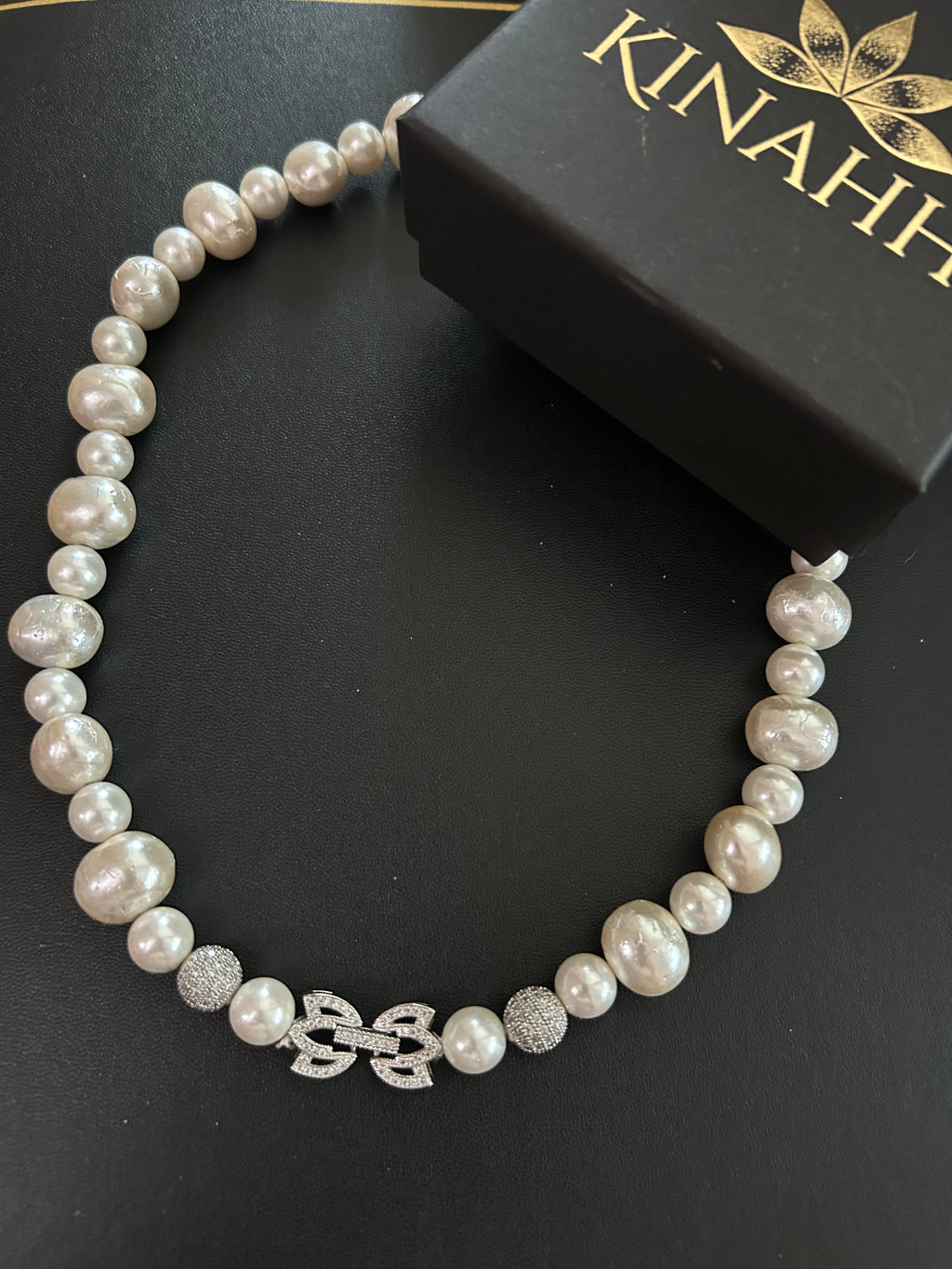 Mehr Necklace detail view showing white shell pearls and an anti-tarnish white metal lock.