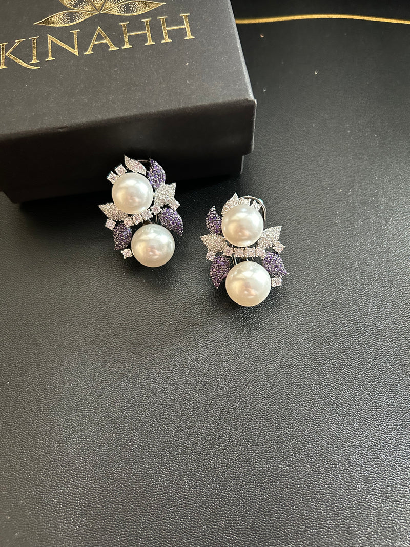 Sephora earrings with white pearl-like accents and purple and clear stone floral details, photographed beside a black KINAHH box.