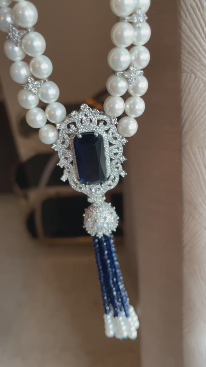 Naaz Necklace video by KINAHH showing shell pearls, American diamond separators, a blue stone pendant and hydro tassel.
