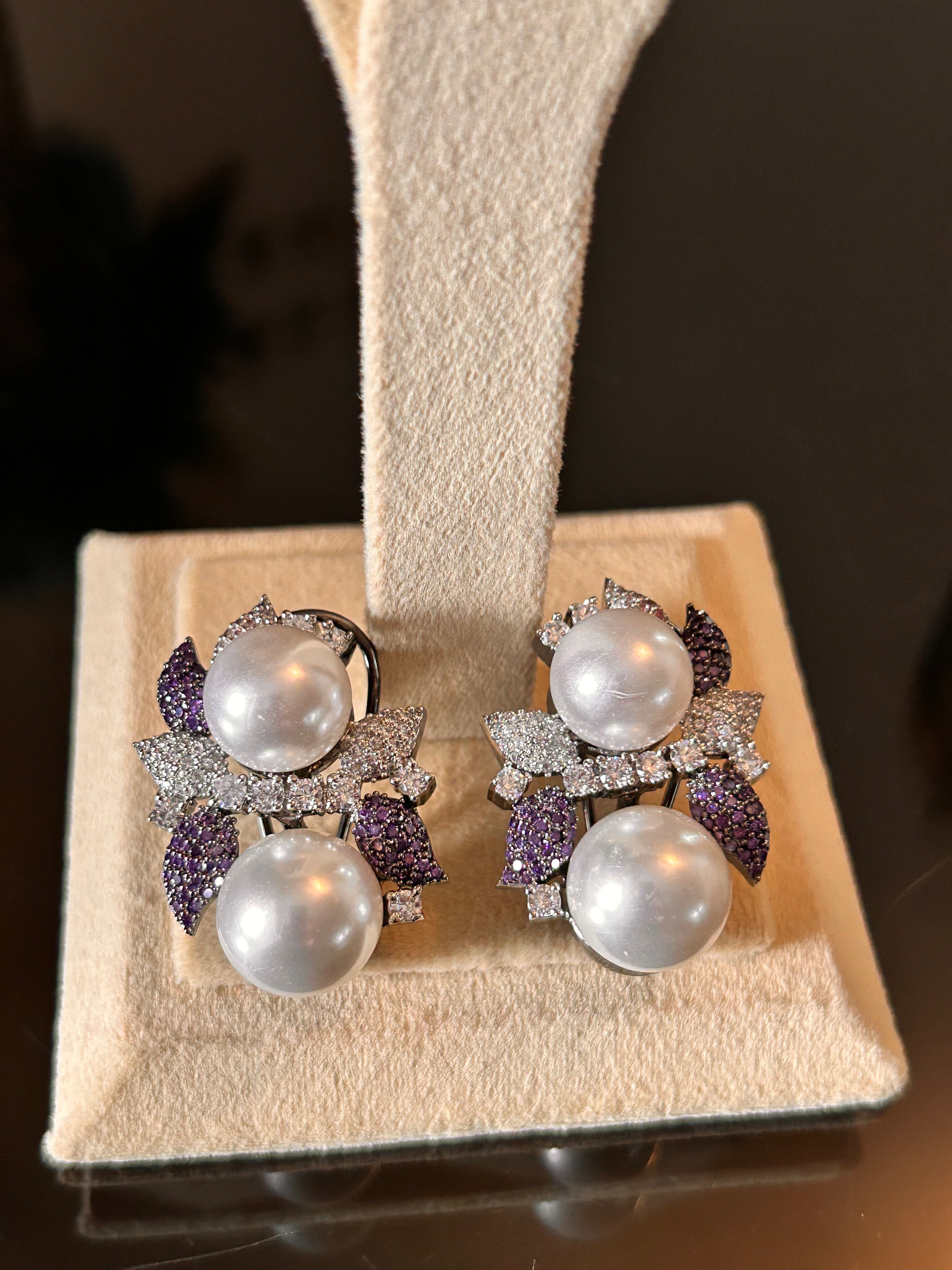 Sephora Earrings shown as a pair on the base of a cream stand, with white pearl-like beads and purple leaf details.