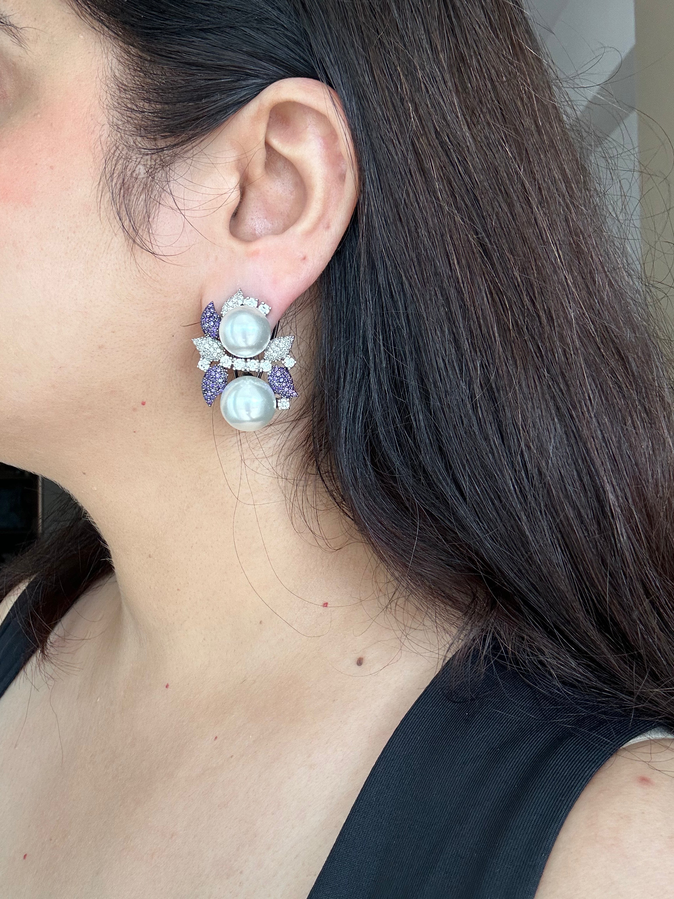 Genuine worn view of Sephora Earrings with purple accents and white pearl-like beads.